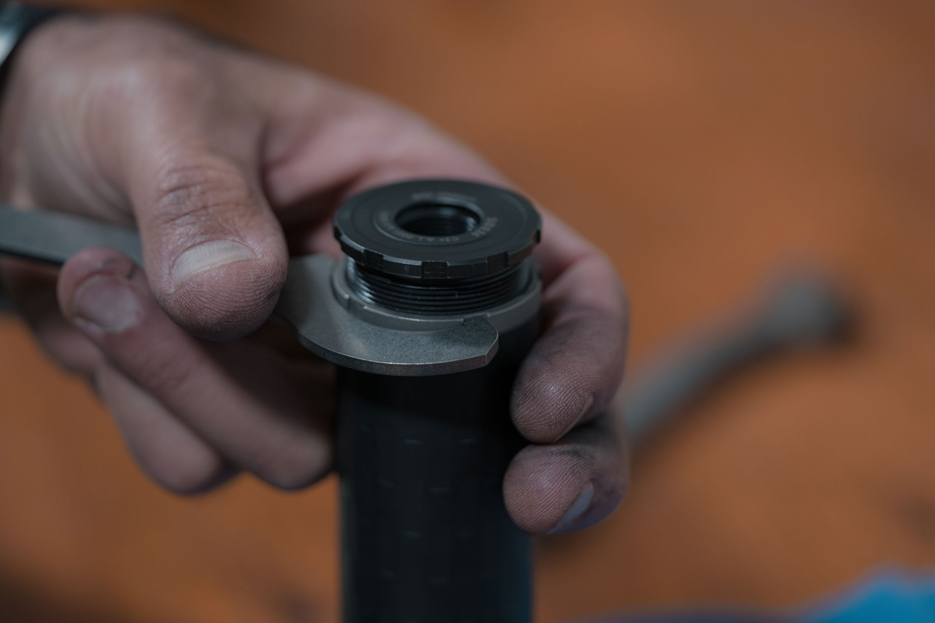 closeup of universal suppressor hub mount being adjusted with a wrench